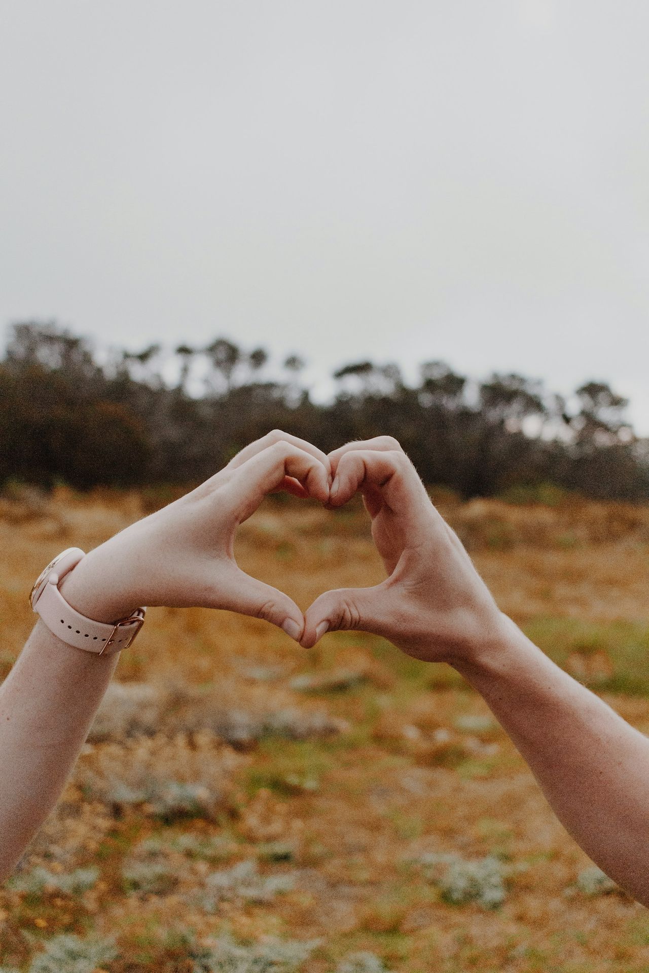 person wearing silver bracelet and white bracelet